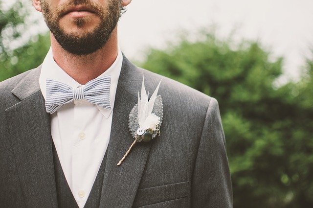 a boutonniere on a man’s dress in the right place